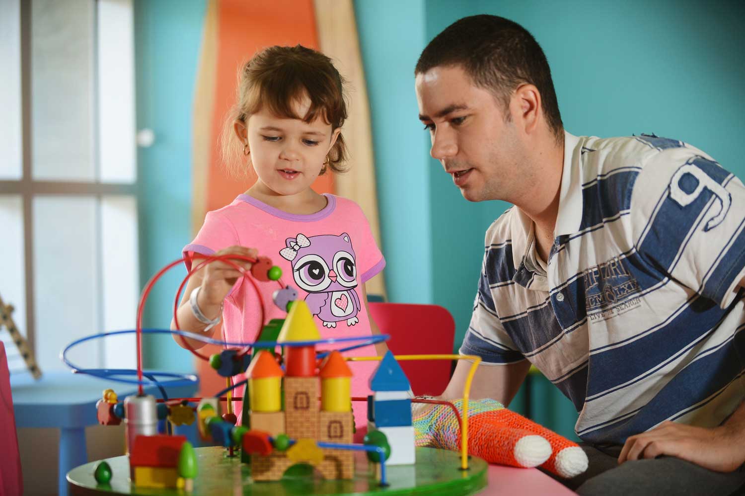 4-year-old girl and her father try out the new kid's toy