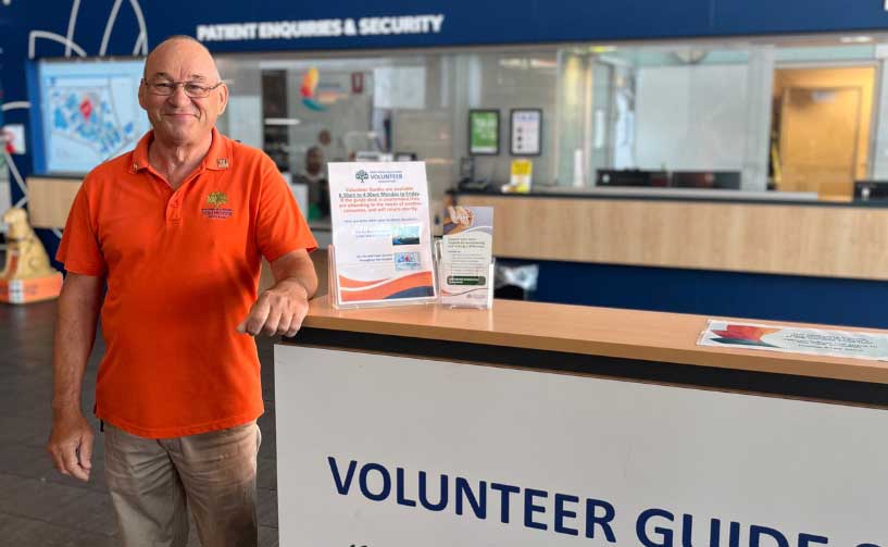 Volunteer standing in the entrance of a hospital