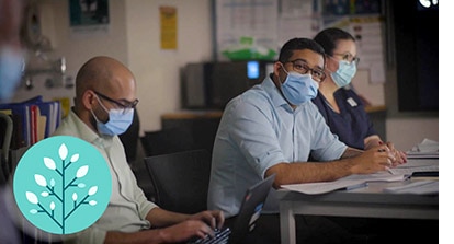 image of staff in masks at desks