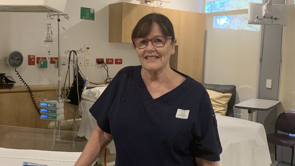 female nurse standing in ward room female nurse standing in ward room