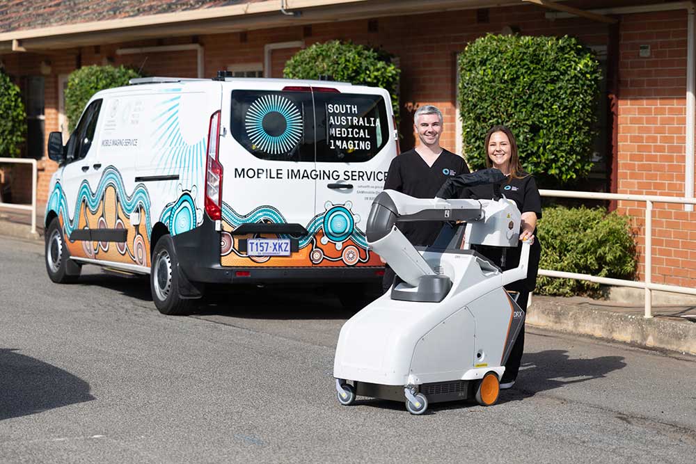 Two SA Medical Imaging staff with mobile equipment next to their van