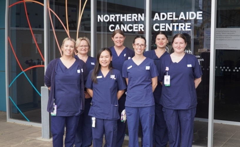 A group of nurses standing in front of the Northern Adelaide Cancer Centre