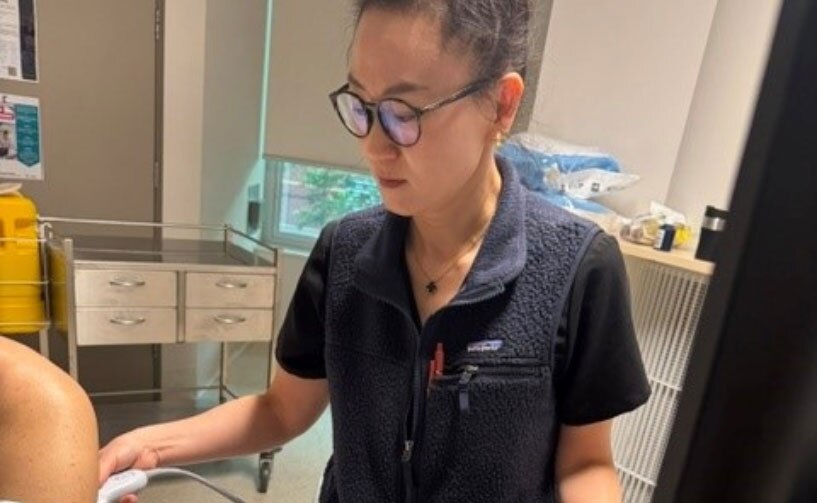 A plural nurse scanning a patient
